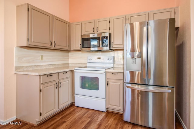 kitchen featuring decorative backsplash, light countertops, light wood-style floors, and stainless steel appliances