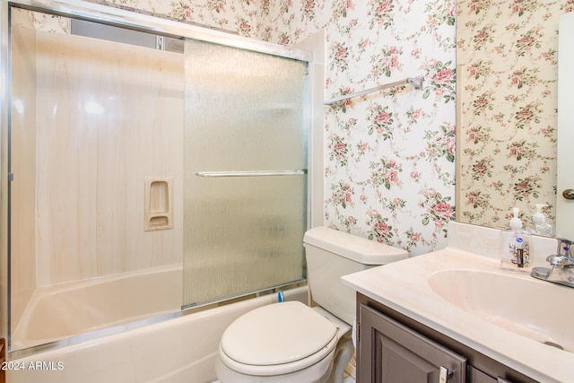 full bath with wallpapered walls, toilet, vanity, and bath / shower combo with glass door