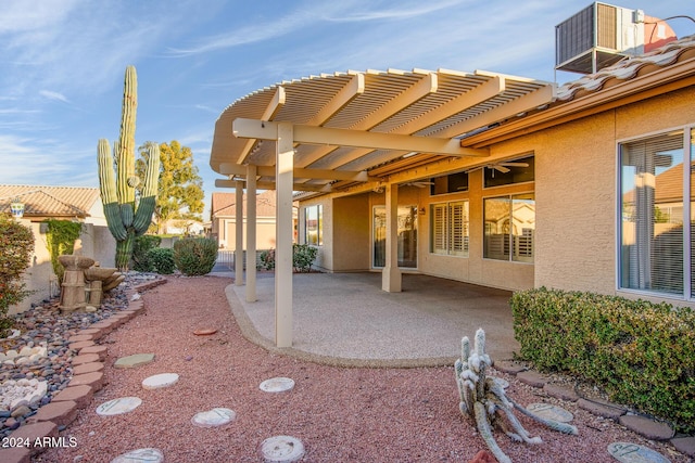 exterior space featuring a patio, central air condition unit, a pergola, and stucco siding