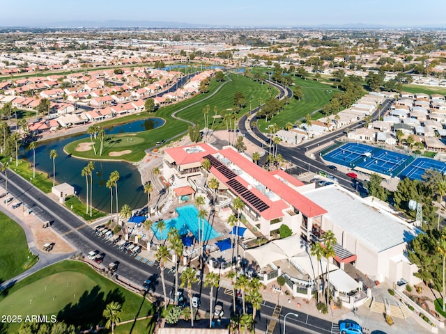 aerial view with view of golf course, a water view, and a residential view