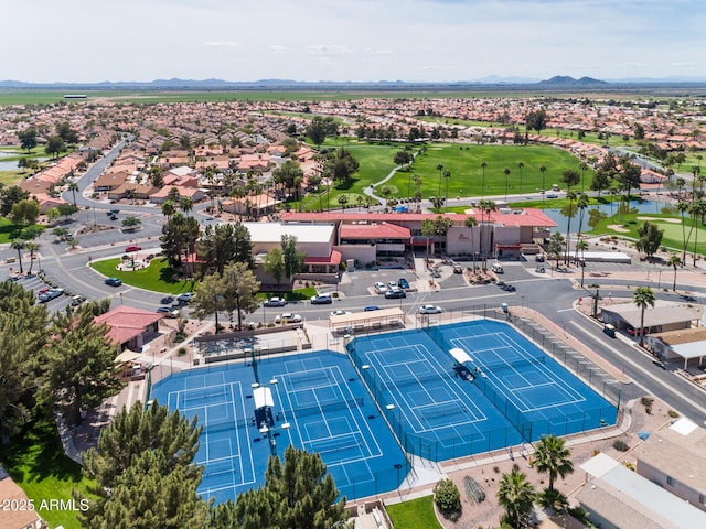 drone / aerial view with a residential view, golf course view, and a water and mountain view