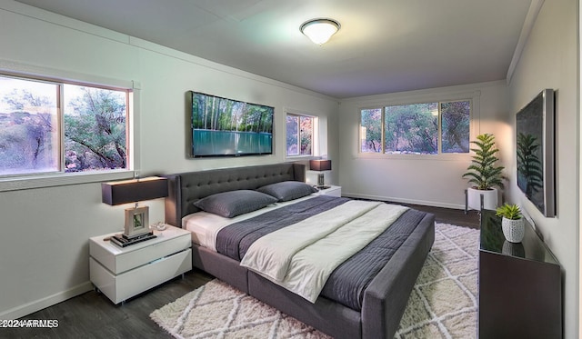 bedroom with dark wood-type flooring