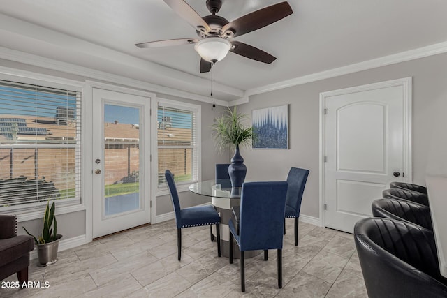 dining space with crown molding and ceiling fan