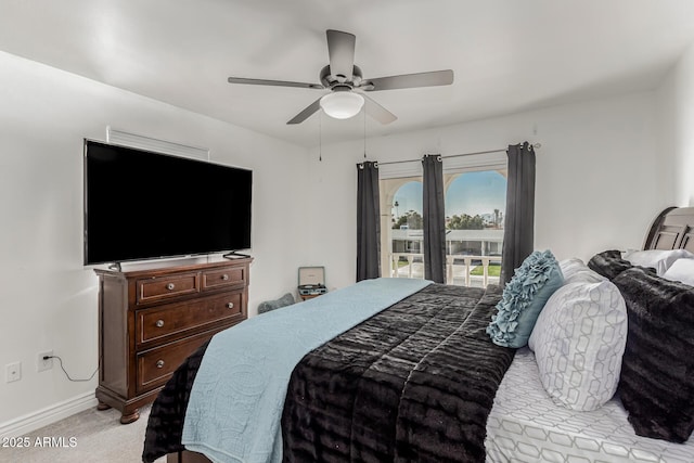 bedroom featuring light colored carpet and ceiling fan