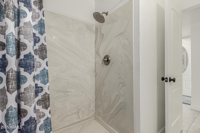 bathroom featuring curtained shower and tile patterned flooring