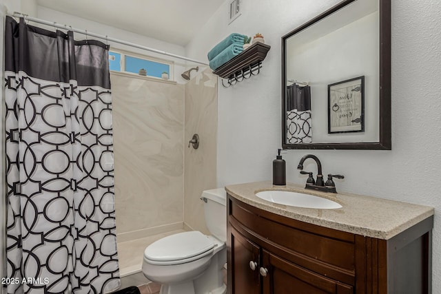 bathroom featuring walk in shower, vanity, and toilet