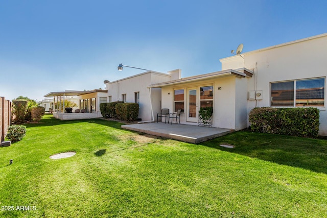 rear view of property with a patio and a yard