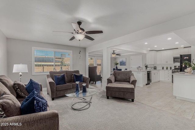 tiled living room featuring ceiling fan