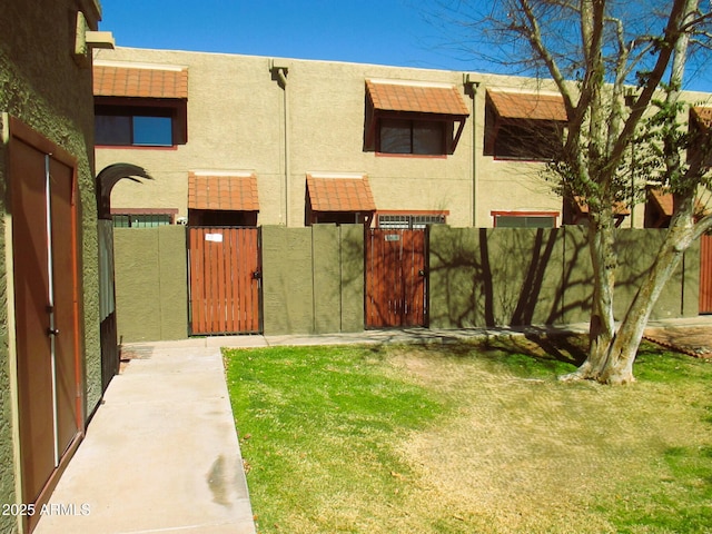 view of yard with a fenced front yard and a gate