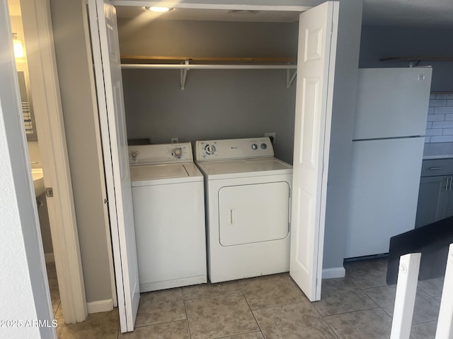 laundry area with light tile patterned floors, laundry area, and washer and dryer