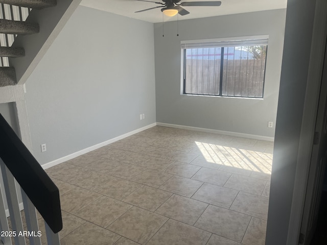 spare room featuring baseboards, a ceiling fan, and light tile patterned flooring