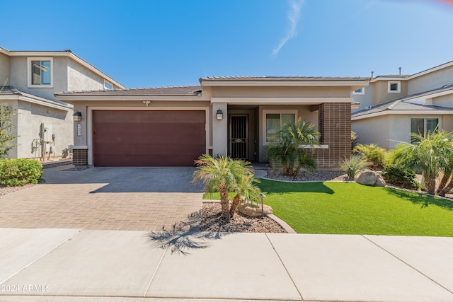 view of front of home with a garage and a front lawn