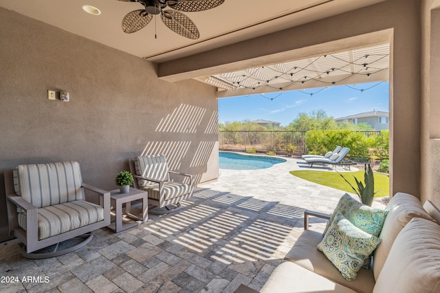 view of patio / terrace featuring ceiling fan and a fenced in pool