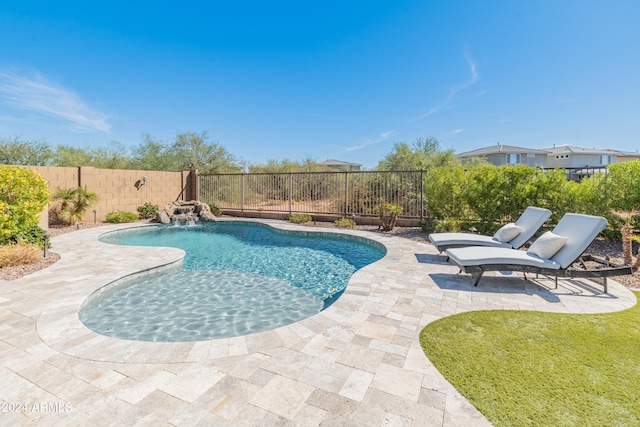 view of pool featuring a patio, pool water feature, and a yard