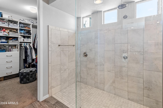 bathroom featuring wood-type flooring and tiled shower