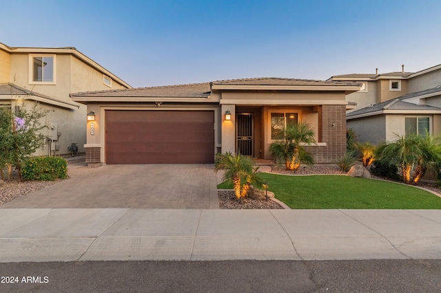 view of front of property featuring a front yard and a garage