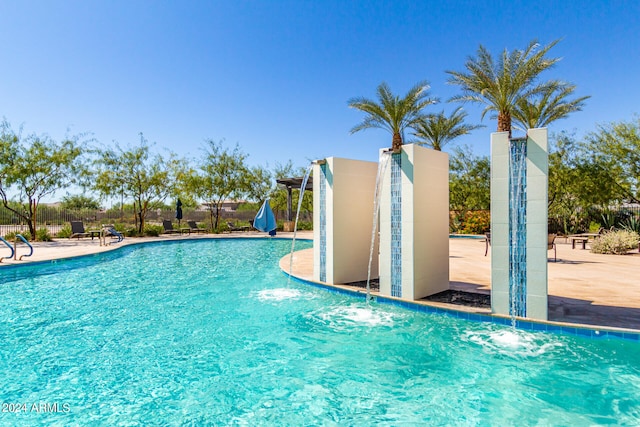 view of swimming pool featuring pool water feature