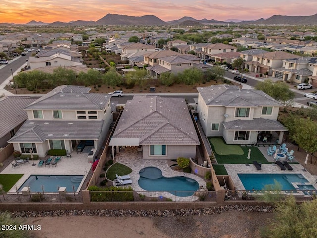 aerial view at dusk featuring a mountain view