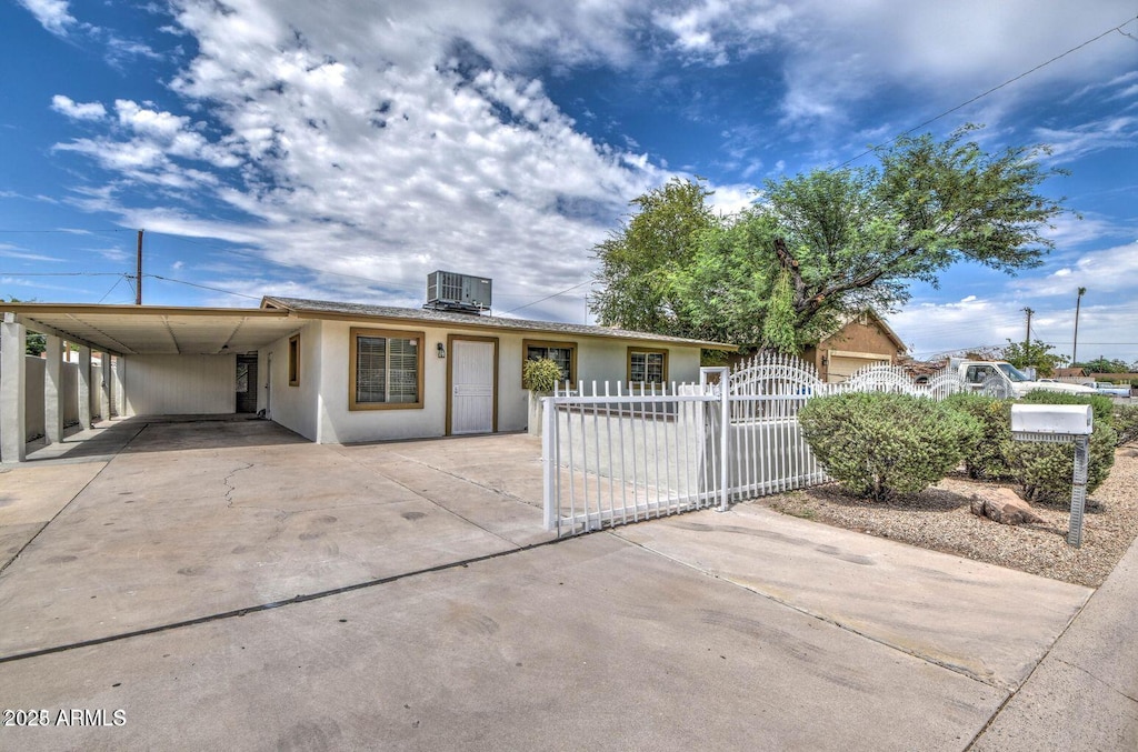 416 W Chambers St, Phoenix, AZ 85041 - ranch-style house with an attached carport, a fenced front yard, cooling unit, driveway, and stucco siding