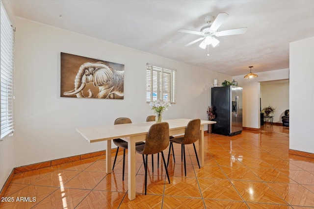 dining room featuring ceiling fan and baseboards