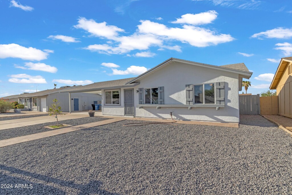 ranch-style house featuring a carport