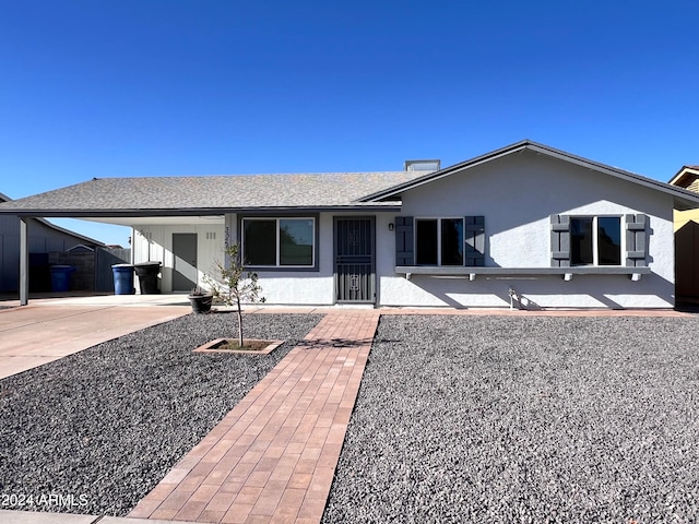 ranch-style house featuring a carport