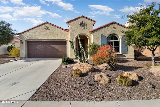 mediterranean / spanish home featuring a garage