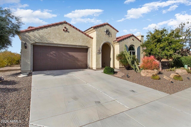 mediterranean / spanish-style home featuring a garage