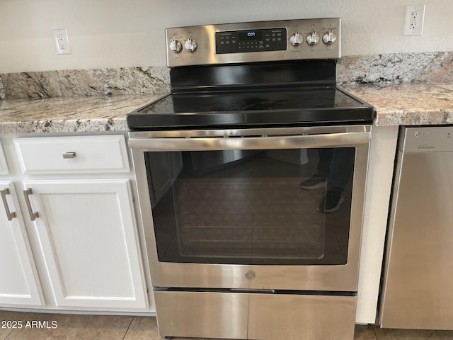 details with dishwashing machine, white cabinets, light countertops, and stainless steel range with electric cooktop