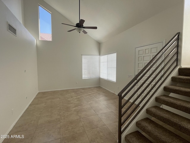 interior space with visible vents, high vaulted ceiling, stairs, and tile patterned flooring