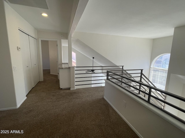 hallway featuring recessed lighting, an upstairs landing, baseboards, and carpet floors