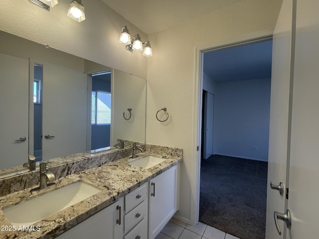 bathroom with tile patterned floors, double vanity, visible vents, and a sink