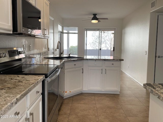 kitchen featuring visible vents, a sink, appliances with stainless steel finishes, white cabinets, and light tile patterned floors