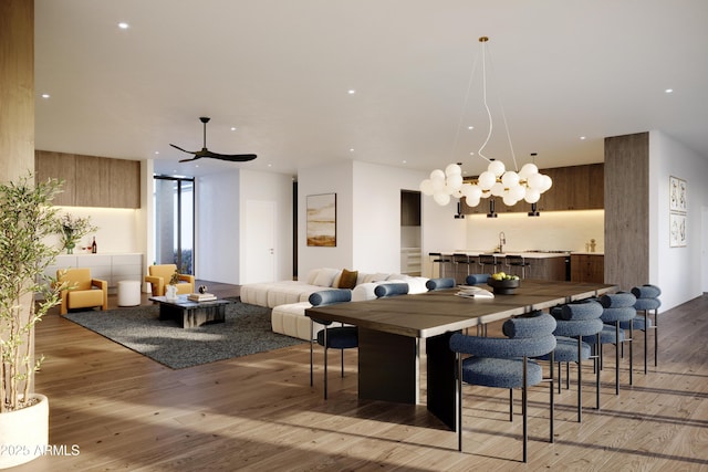 dining area with ceiling fan with notable chandelier, light hardwood / wood-style flooring, and floor to ceiling windows