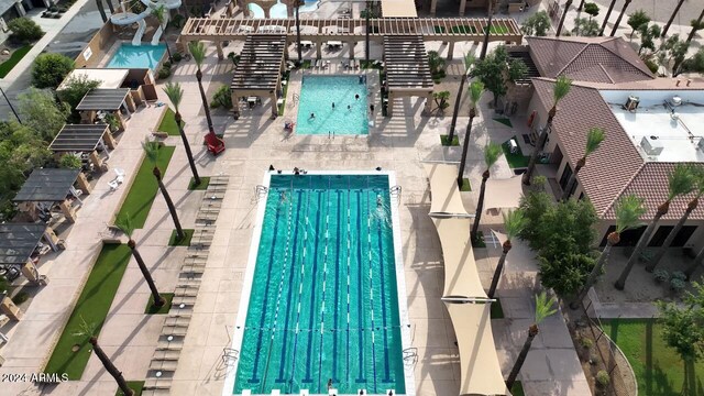 view of pool with a patio and a water slide