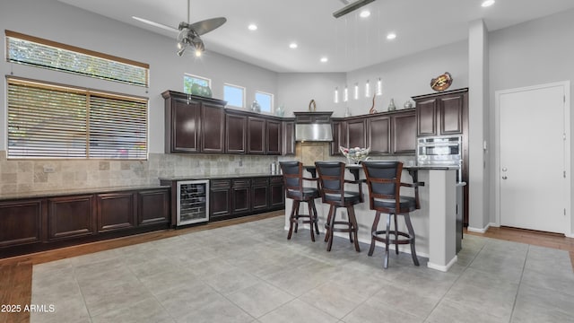 4276 E Meadowview Dr, Gilbert, AZ 85298 - kitchen featuring wine cooler, a kitchen bar, recessed lighting, a ceiling fan, and backsplash