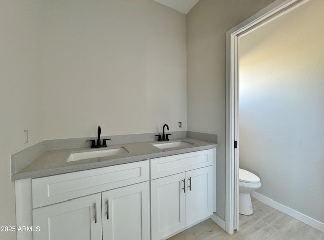 bathroom with vanity, hardwood / wood-style flooring, and toilet