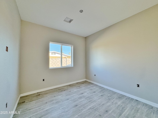 unfurnished room with light hardwood / wood-style floors