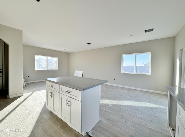 kitchen with a center island and white cabinets