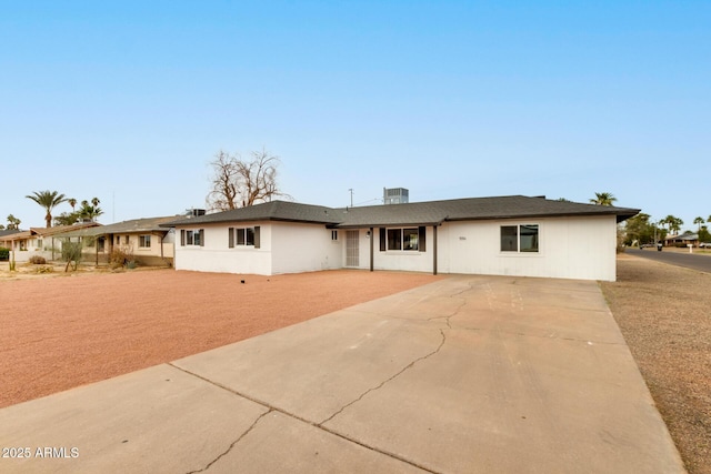 ranch-style home featuring central air condition unit and driveway