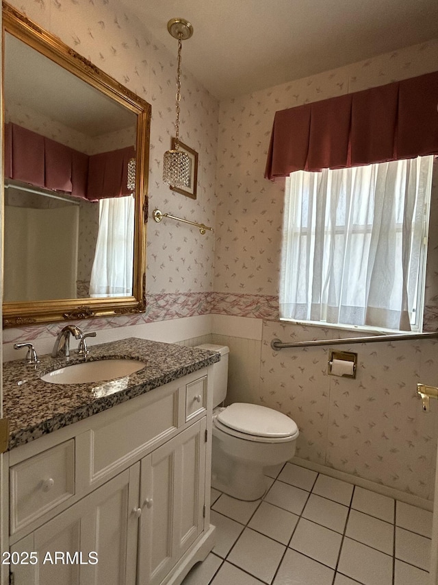 bathroom with vanity, tile patterned floors, and toilet