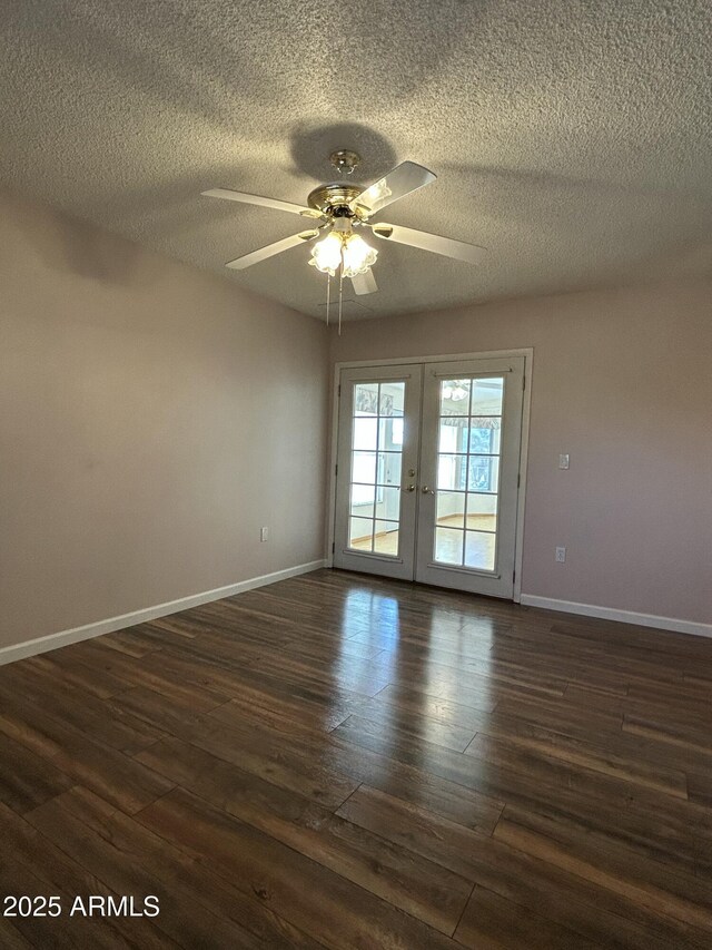 spare room featuring french doors, ceiling fan, dark hardwood / wood-style floors, and a textured ceiling