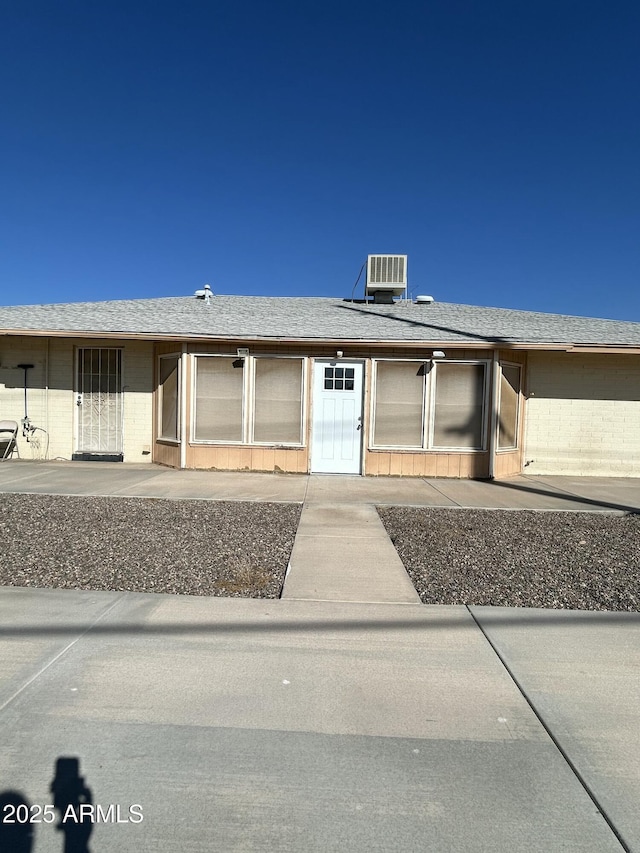 view of front of house with cooling unit and a patio area