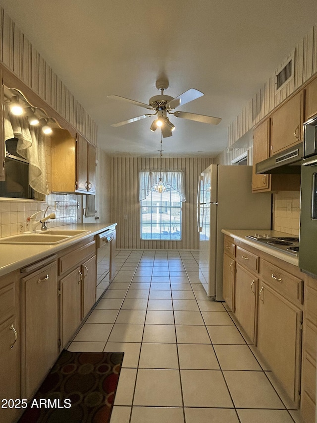 kitchen featuring light tile patterned flooring, sink, decorative backsplash, ceiling fan, and white appliances