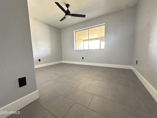 5924 W Tierra Buena Ln, Glendale, AZ 85306 - empty room with tile patterned floors, ceiling fan, and baseboards