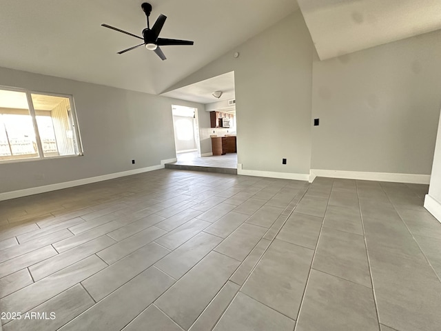 5924 W Tierra Buena Ln, Glendale, AZ 85306 - unfurnished living room featuring lofted ceiling, a ceiling fan, baseboards, and tile patterned flooring