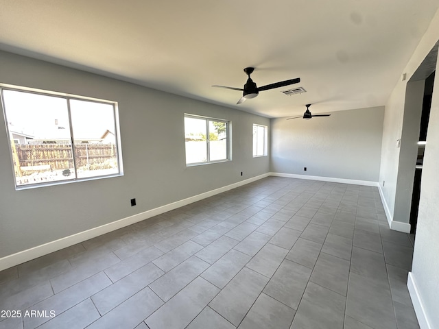 5924 W Tierra Buena Ln, Glendale, AZ 85306 - spare room featuring ceiling fan, dark tile patterned flooring, and baseboards