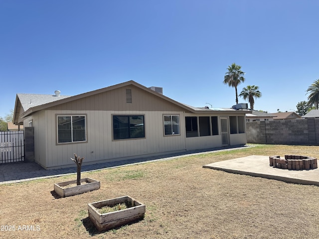 5924 W Tierra Buena Ln, Glendale, AZ 85306 - rear view of property with a fire pit, a fenced backyard, a patio, a garden, and a sunroom