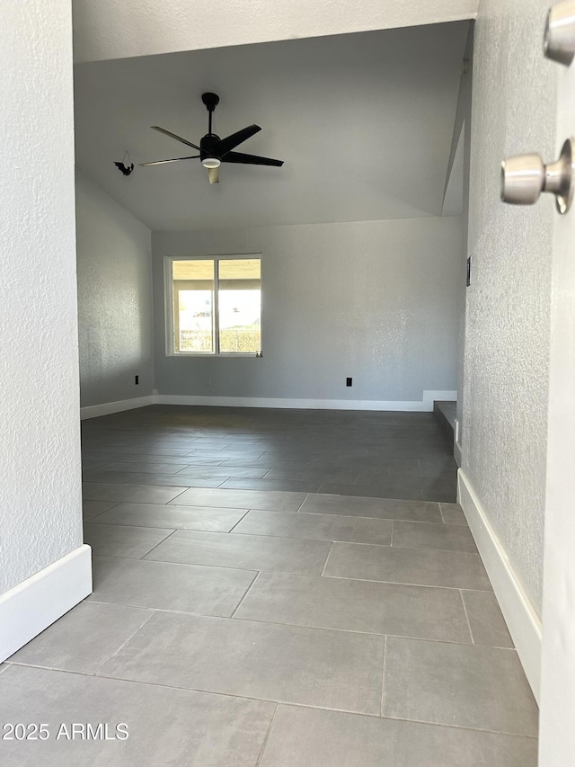 5924 W Tierra Buena Ln, Glendale, AZ 85306 - tiled empty room with a textured wall, ceiling fan, and baseboards