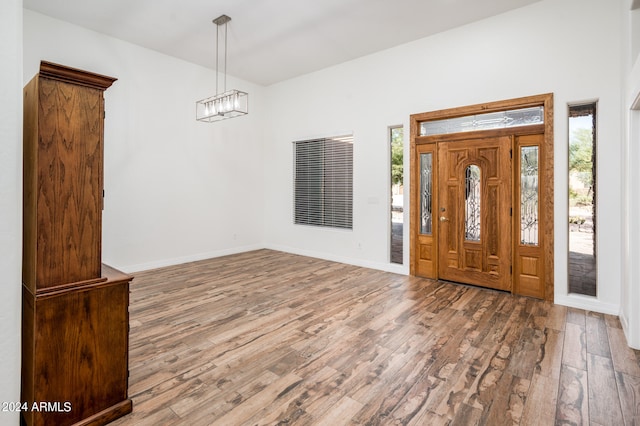 entryway featuring hardwood / wood-style floors and a notable chandelier